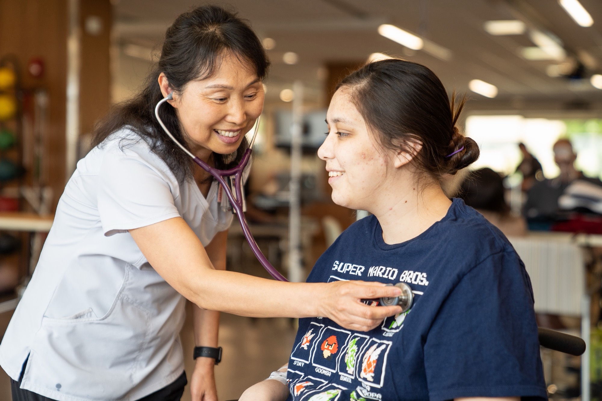 A nurse and a patient talking in a hospital room