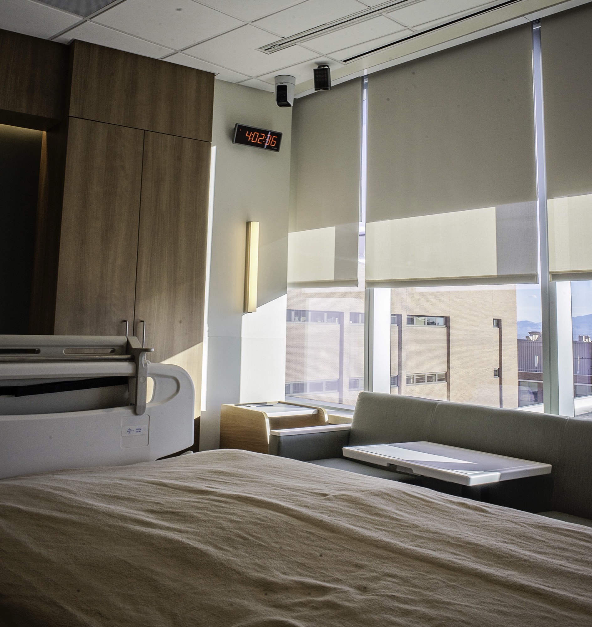 A smart hospital room with the control tablet mounted at the bedside